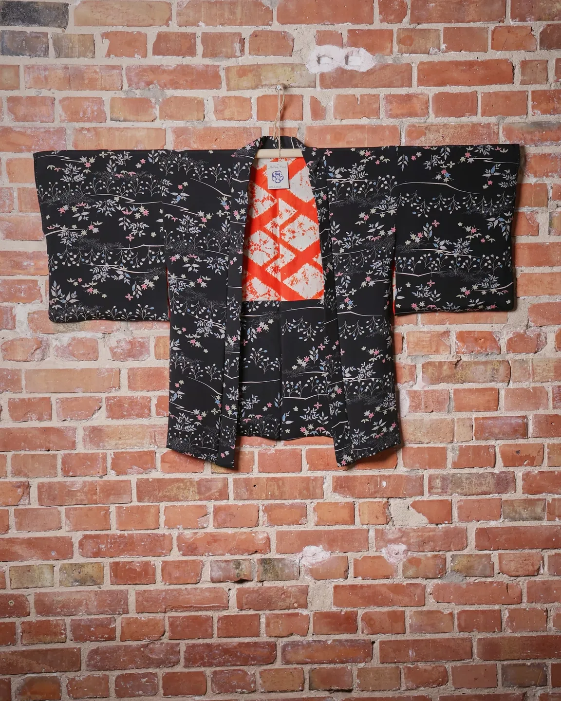 Black floral haori with an orange lining — view 1