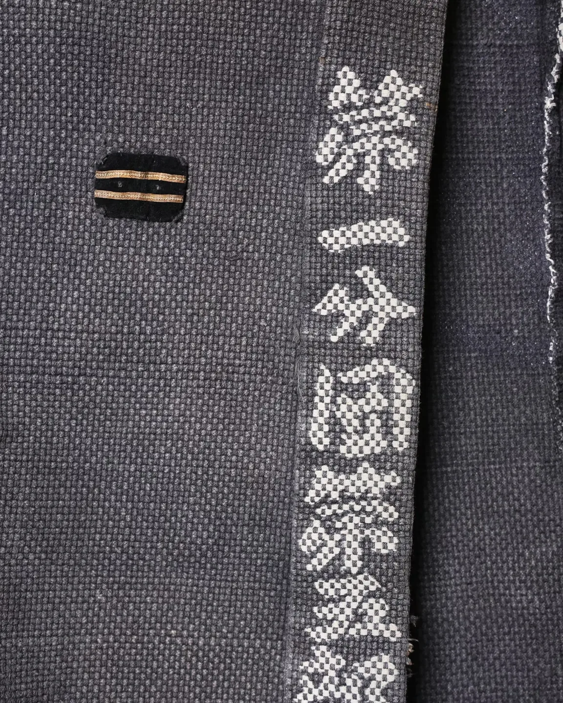 Dark jacket with lettering and red trim — view 3