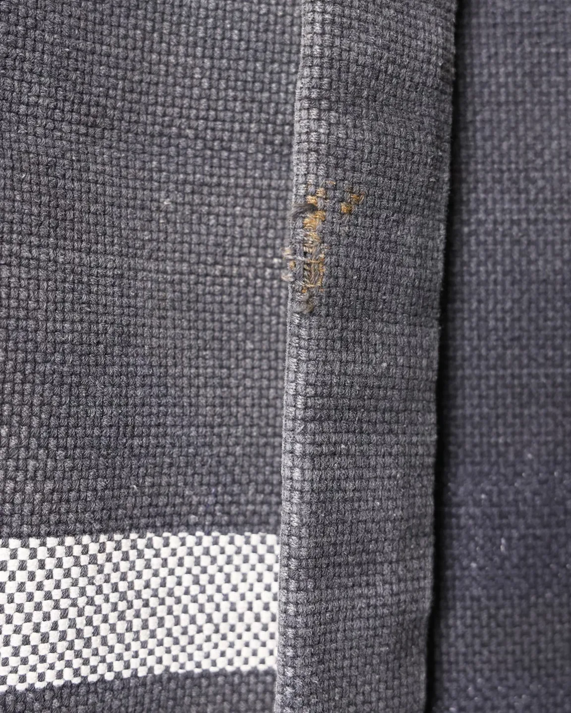 Dark jacket with lettering and red trim — view 4