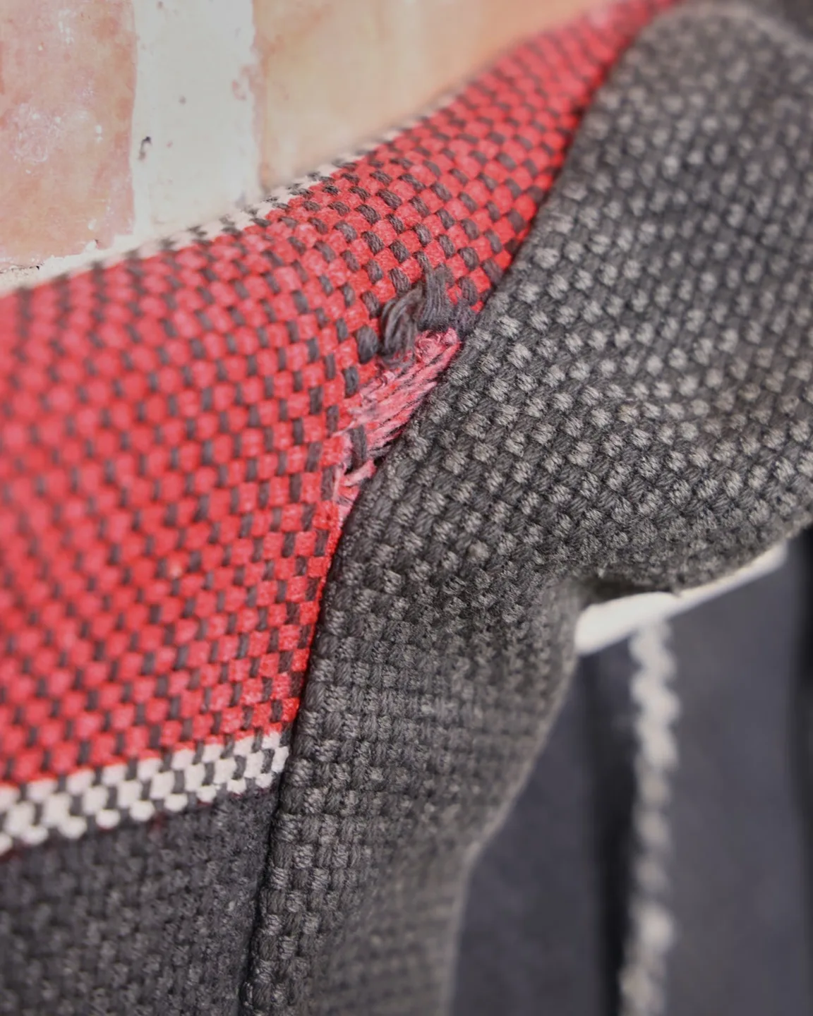 Dark jacket with lettering and red trim — view 5