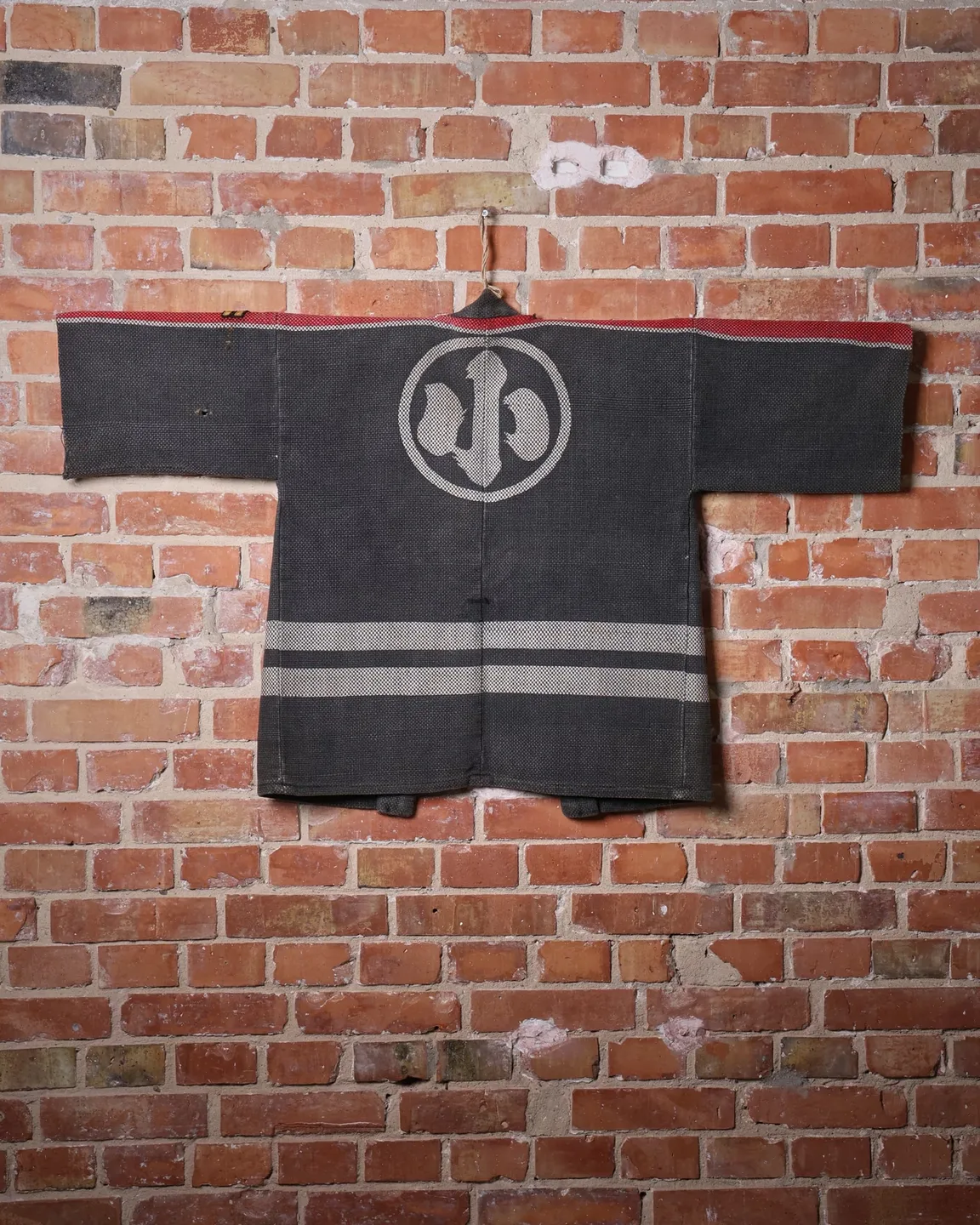 Dark jacket with lettering and red trim — view 6