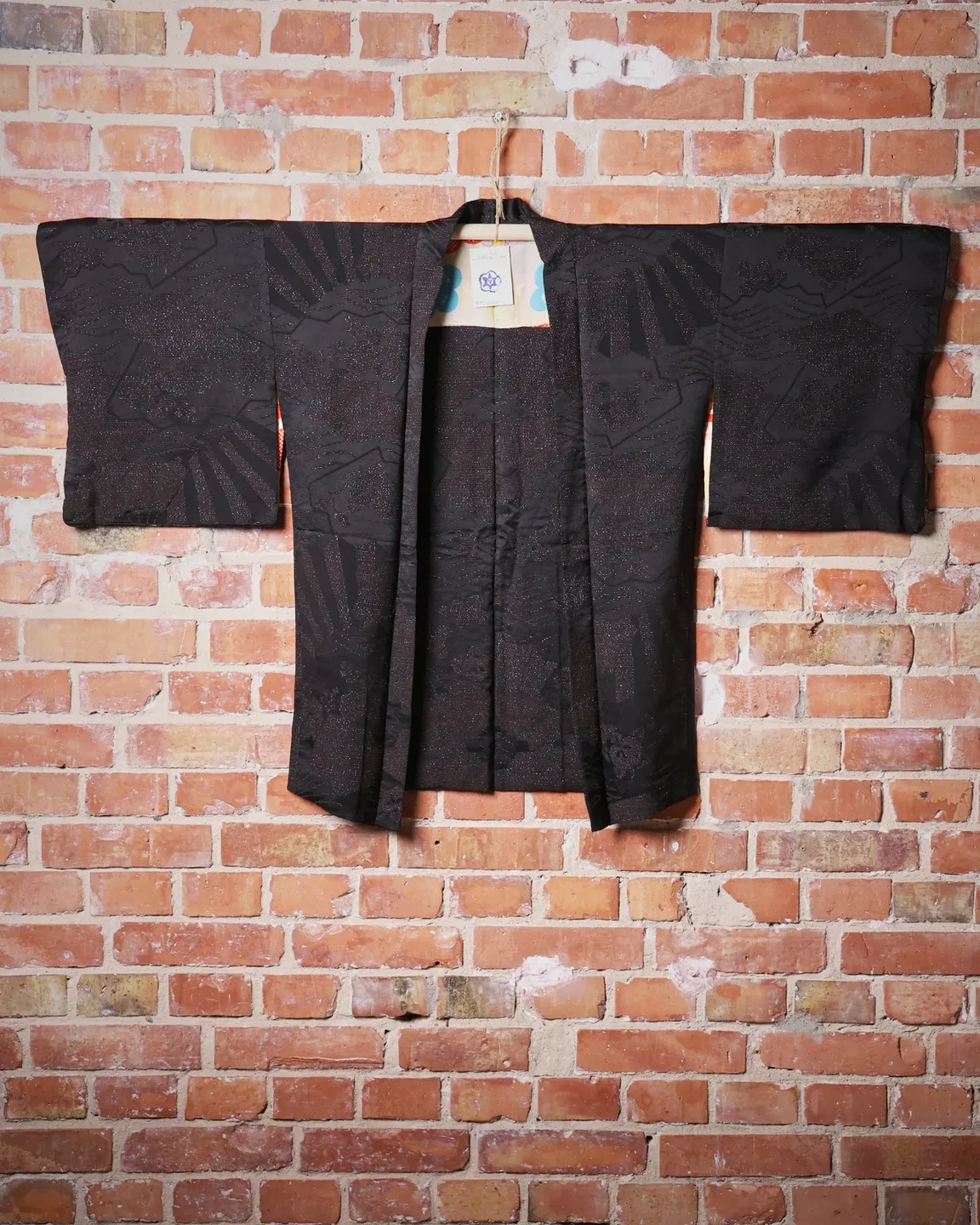 Black haori with a woven pattern and floral lining — view 1