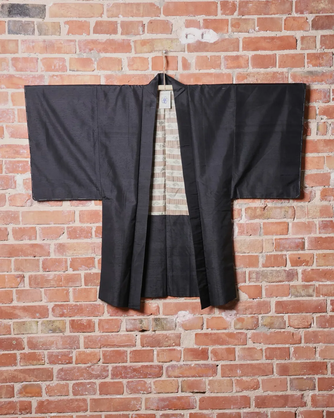 Dark textured haori with a pale striped lining — view 1