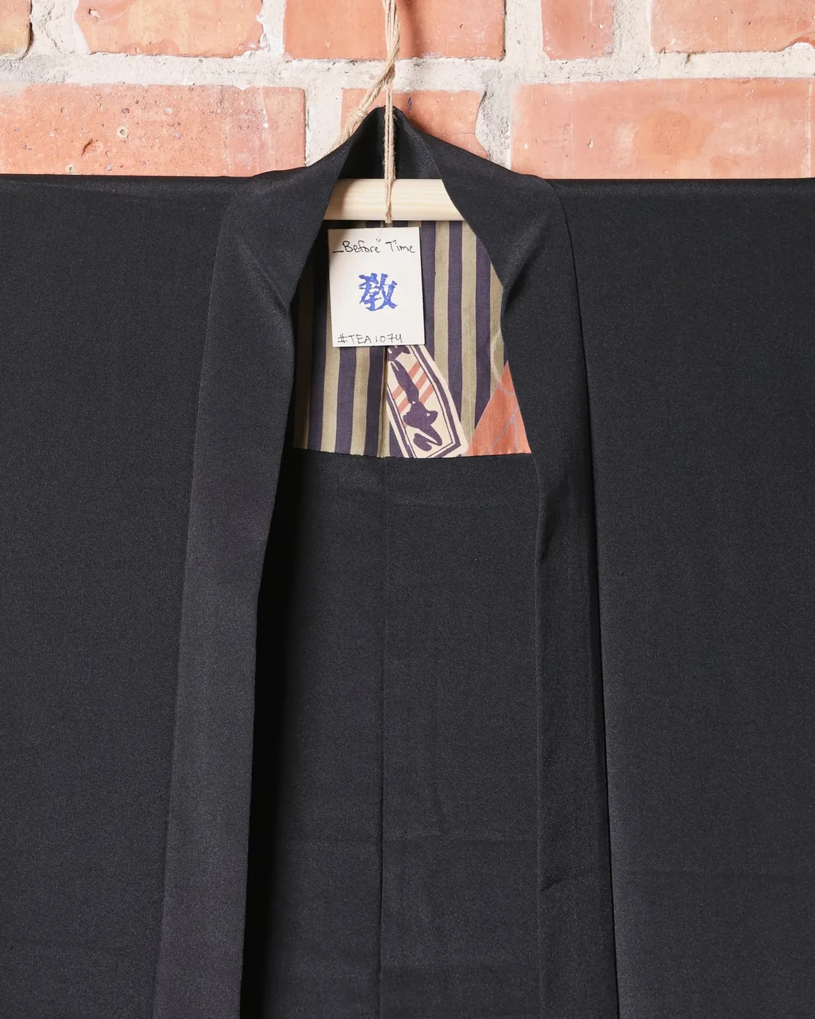 Black haori with white crests and striped lining — view 2