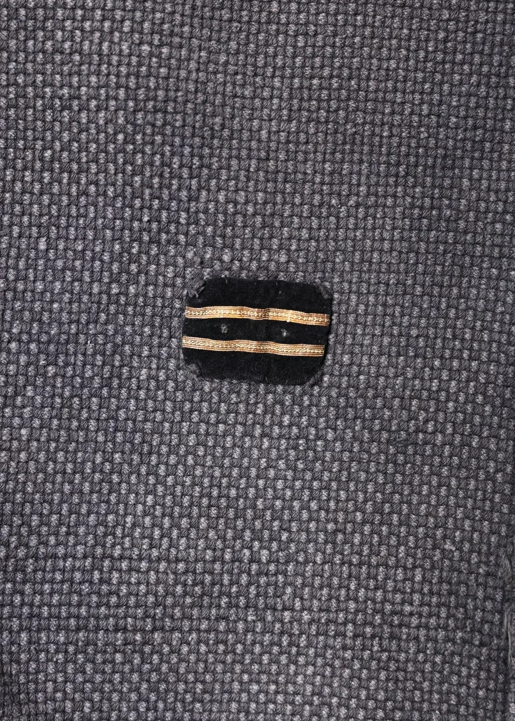 Dark jacket with lettering and red trim — view 2